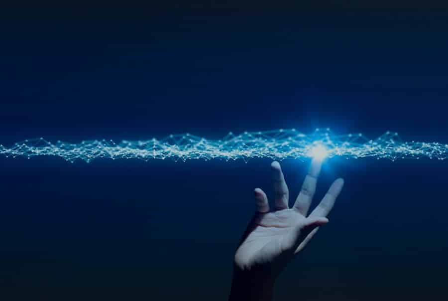 Hand touching a blue light beam of interconnected wires