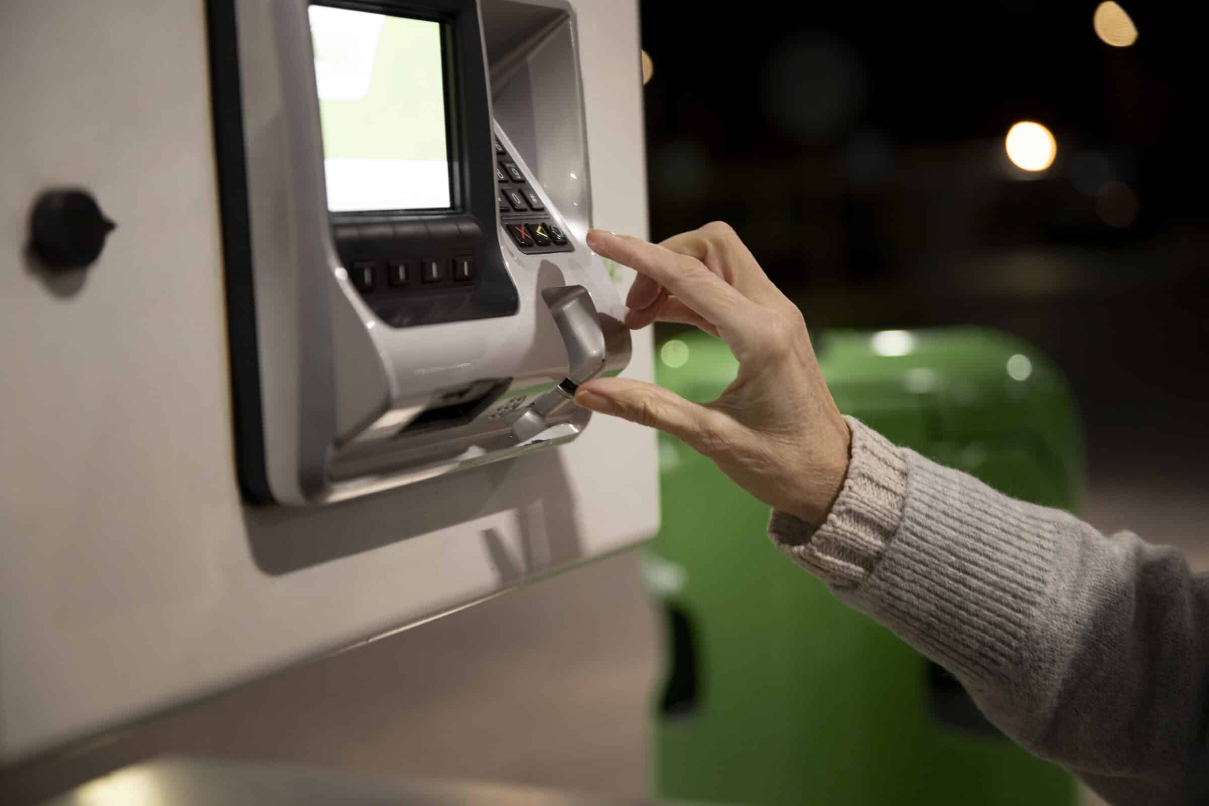 Woman using an ATM with built-in facial recognition